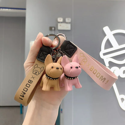 PawCharm French Bulldog keychains in black, pink, burgundy and tan, arranged together.