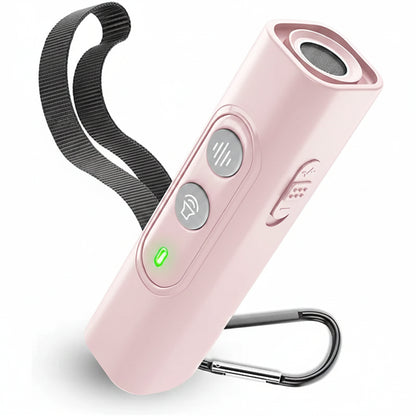 Soft pink handheld ultrasonic dog bark training device with black lanyard and metal carabiner clip on neutral surface