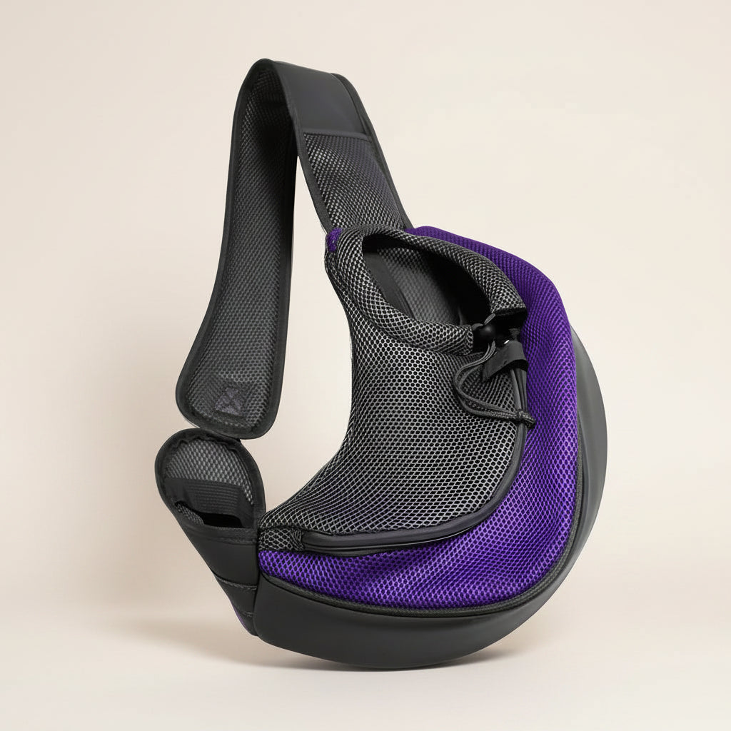 Purple hands-free pet sling carrier with adjustable padded strap and mesh side panel for cats and small dogs. 