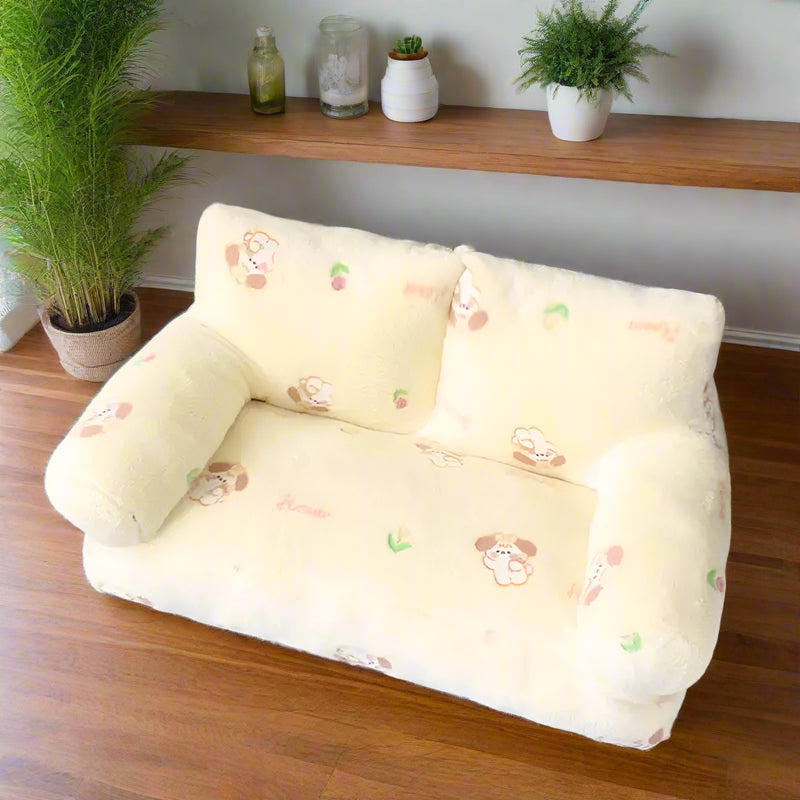 Sofa-style pet bed in blue bunny print — M size shown with padded arms and backrest — SniffWaggleNWalk